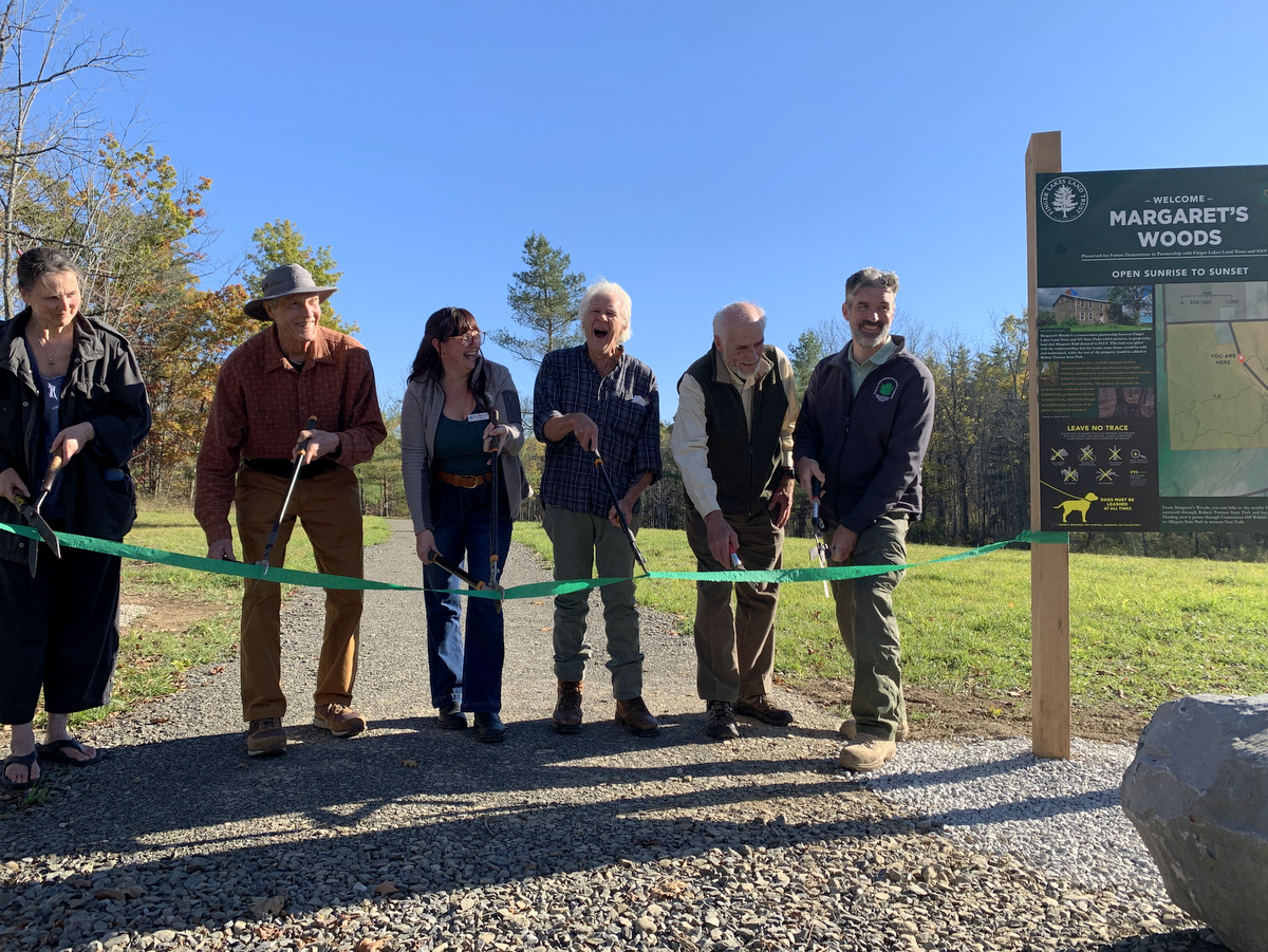 People cutting a ribbon to celebrate new hiking trails